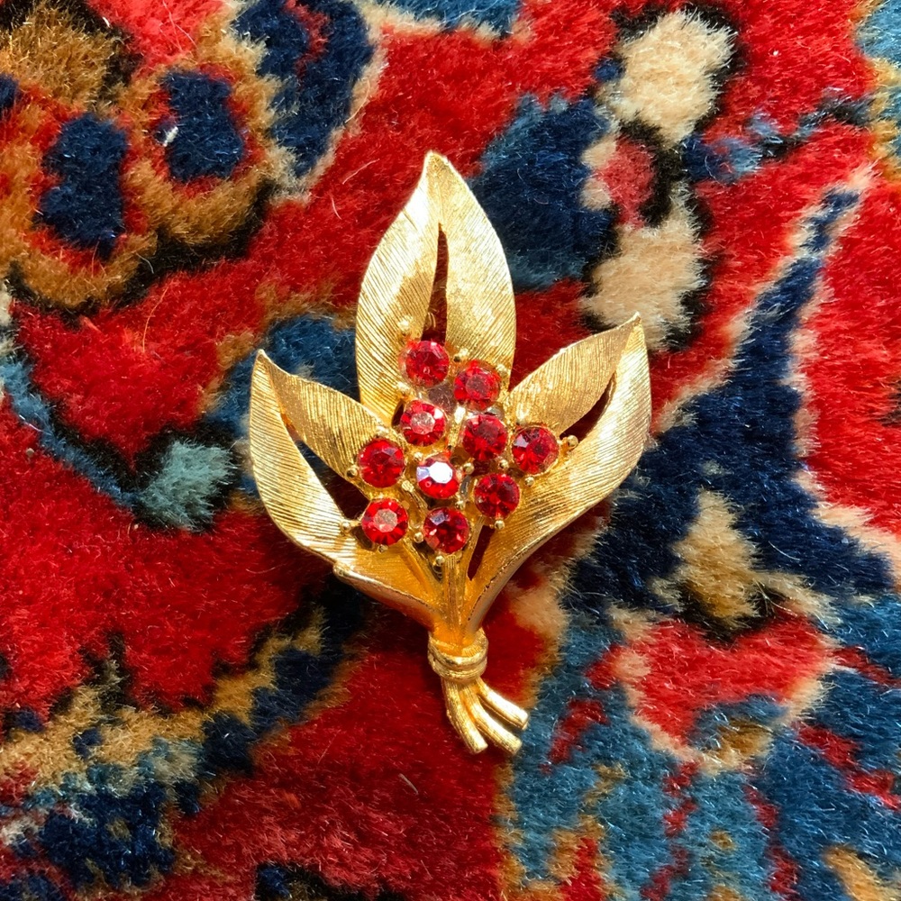 Vintage gold tone with red rhinestones stamped JJ brooch